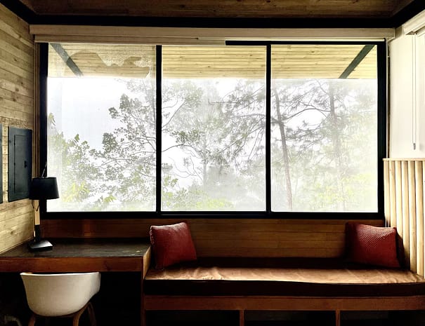 Crystal Cabin Cerro Azul surrounded by lush greenery 01