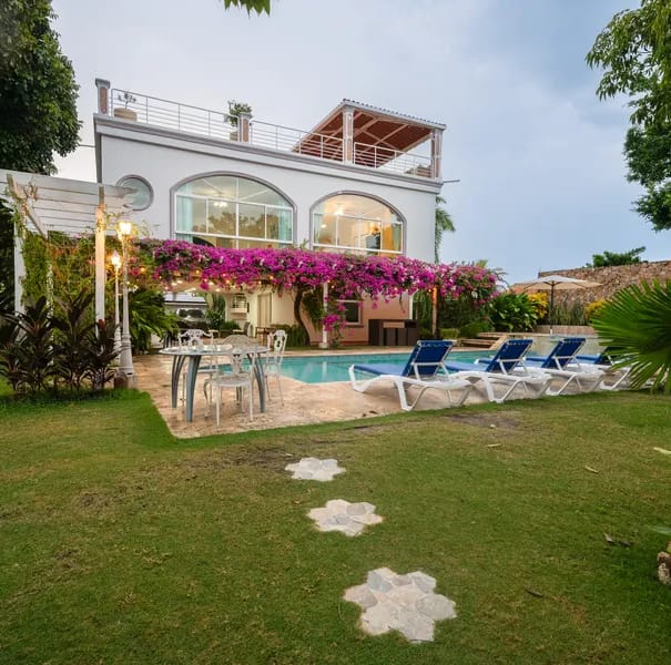 Exterior of a beachfront villa in Punta Chame showing a private pool, jacuzzi, tropical gardens, and illuminated facade at dusk by Bannaba Stays in Panama