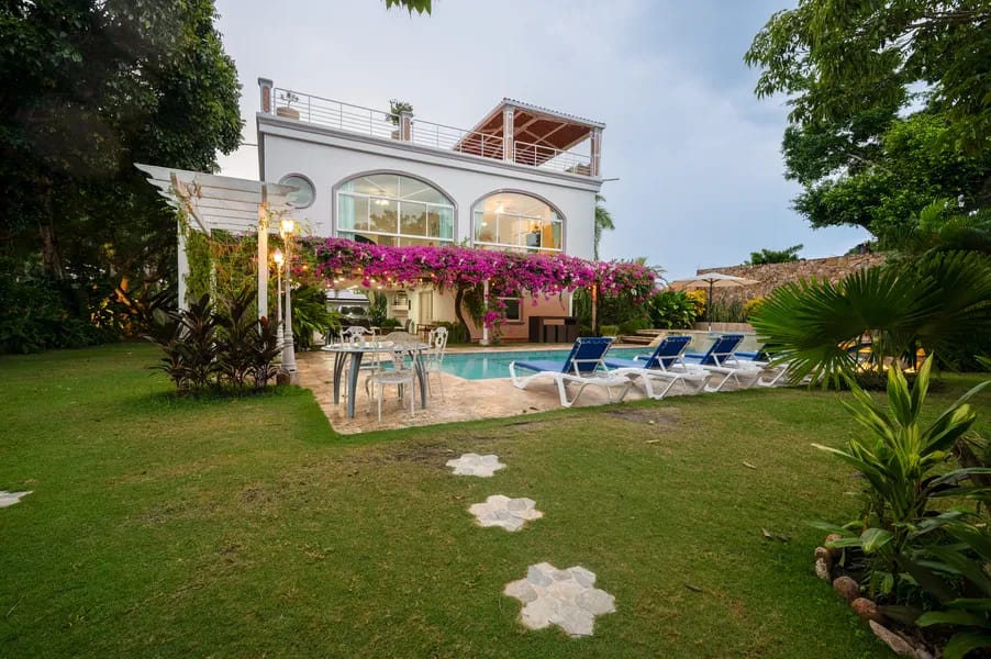 Exterior of a beachfront villa in Punta Chame showing a private pool, jacuzzi, tropical gardens, and illuminated facade at dusk by Bannaba Stays in Panama